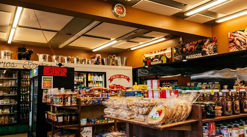 A bustling Mexican grocery store interior, with shelves stocked with various products and food items.